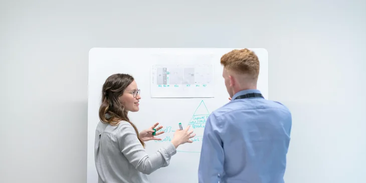 A female engineer delivering a presentation to her coworkers.