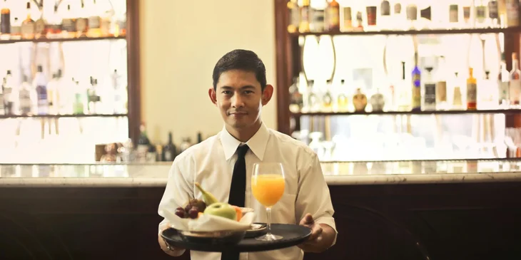 A waiter about to serve food.