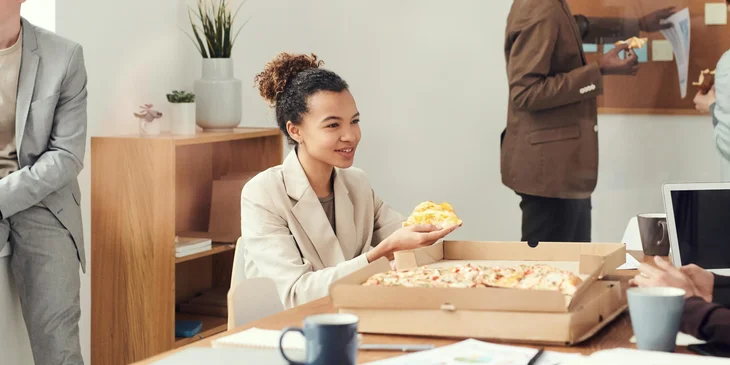 People in an office having a lunch break.