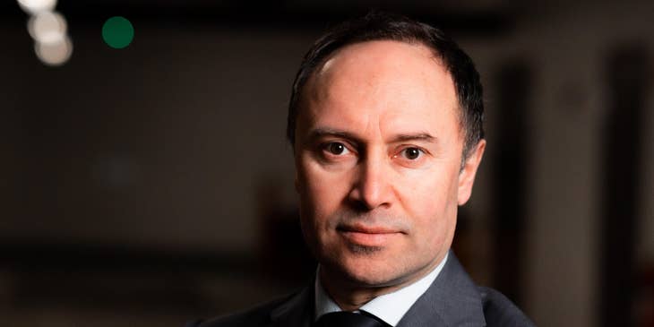 c-level executive dressed in suit and crossing arms