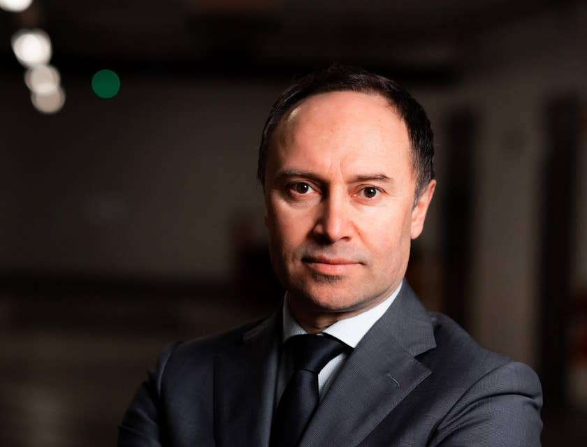 c-level executive dressed in suit and crossing arms
