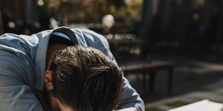 An employee quiet quitting by taking a nap during their work hours.