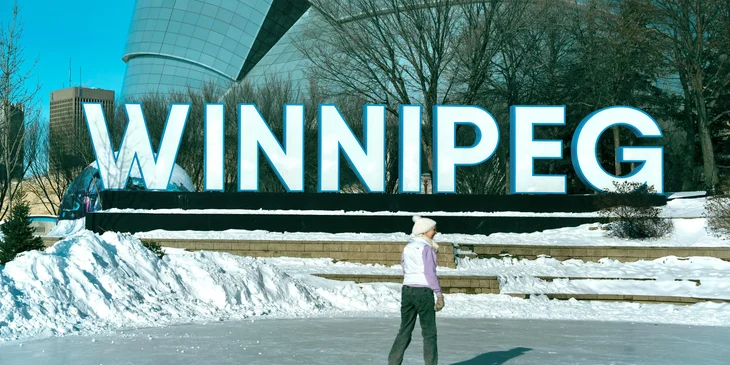 A Winnipeg sign in an ice-skating rink.
