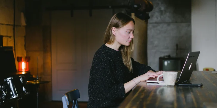 A woman using a laptop at home.