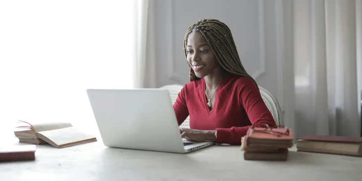 A woman working on her laptop.