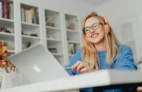 A woman working on her laptop.