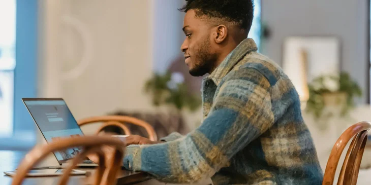 A man working on his laptop.