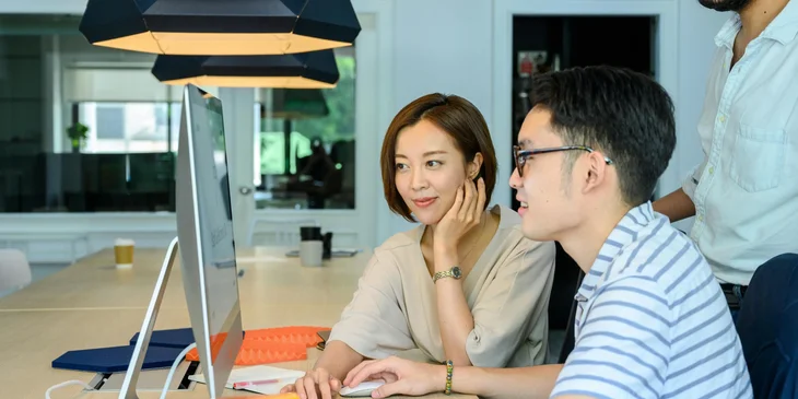 A man and a woman collaborating on a project.