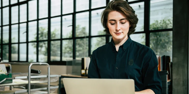 A woman working at her desk.