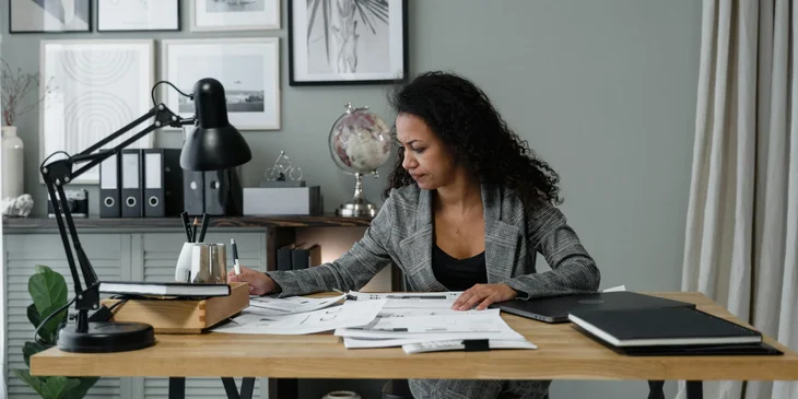 A woman working on her office table.