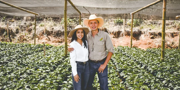 Two farmers standing in a field.