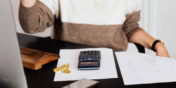 Billing Coordinator with a calculator and a few papers on a desk