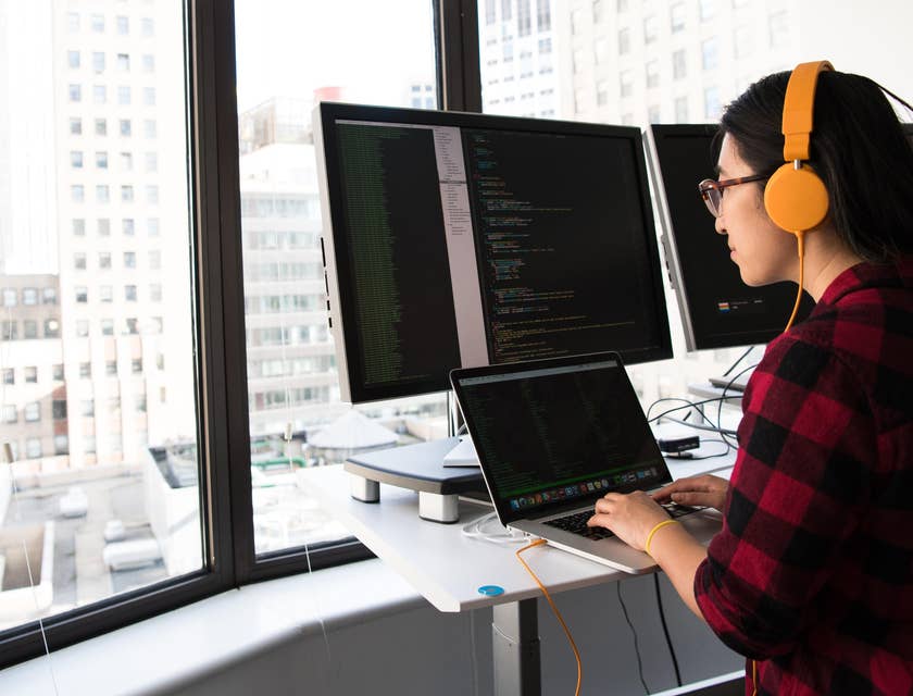 Blockchain Developer wearing a pink headset and working on the new application