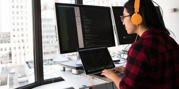 Blockchain Developer wearing a pink headset and working on the new application