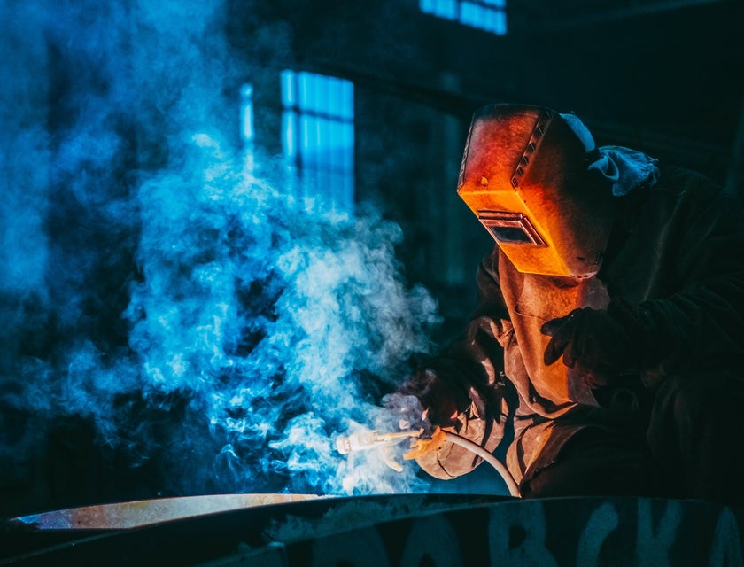 A worker welding metal.