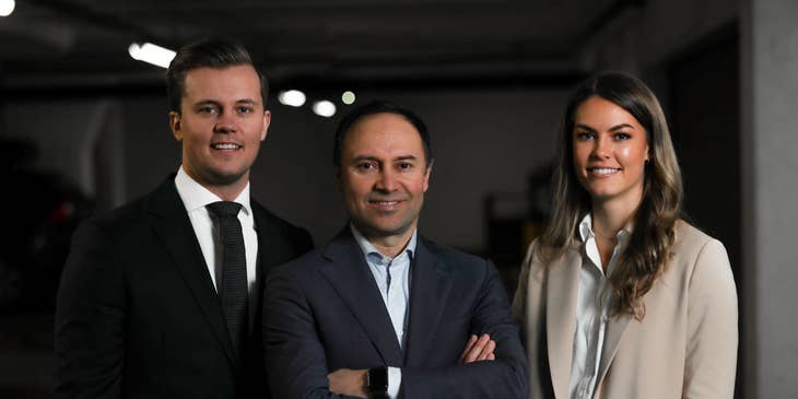 Board Members wearing business suits while standing and posing for the camera for a corporate shoot