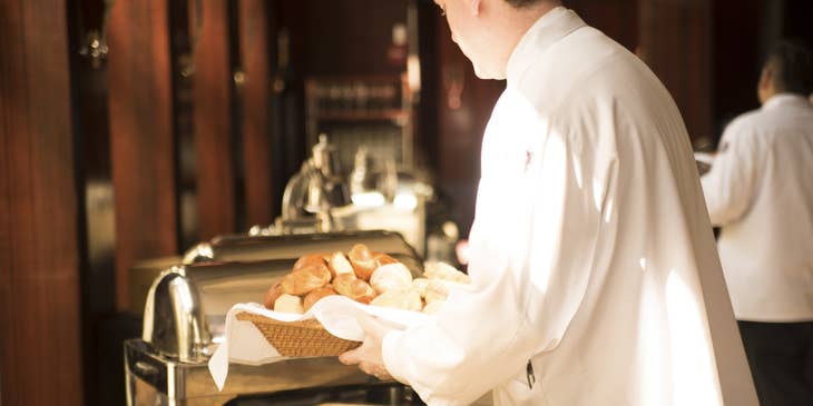 Breakfast Attendant sets up the meal before guests arrives.