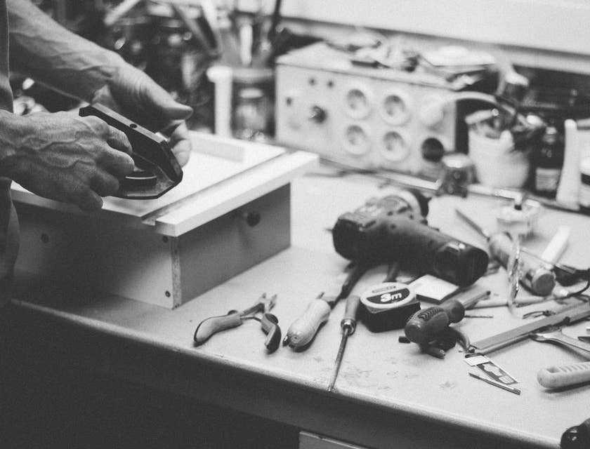 black and white photo of Cabinet Maker making a drawer as part of cabinetry