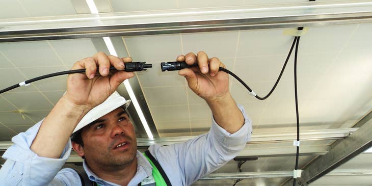 man installing cables in a building