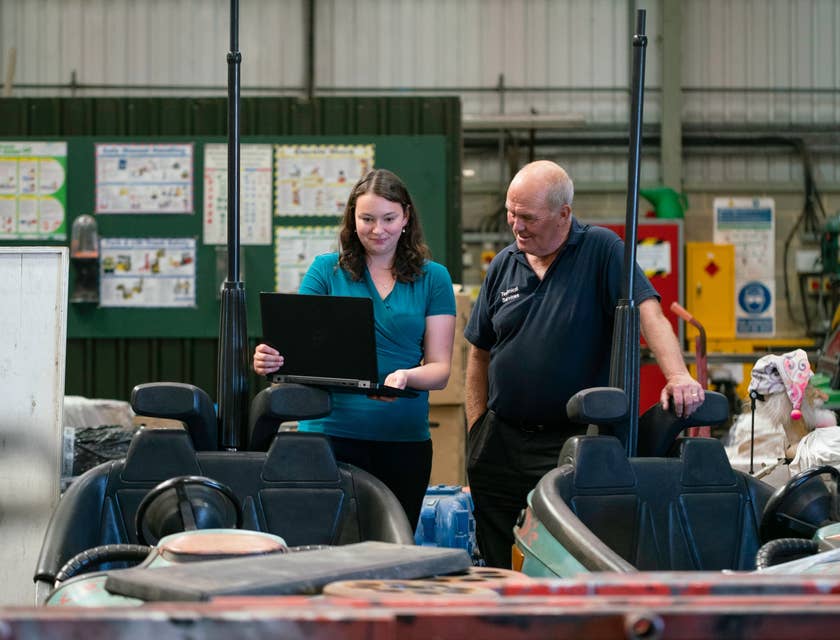CAD Operator showing new draft plans to her manager in a workshop