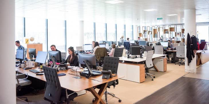 photo of an office setup with a team working at their respective workstations
