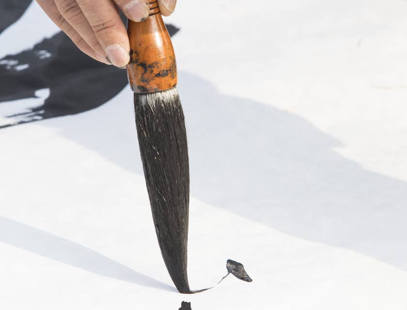 Calligrapher holding a calligraphy brush