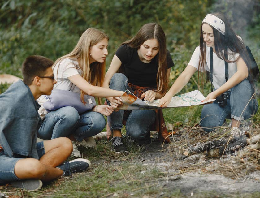 Camp Counselor teaching a group of campers how to read a map
