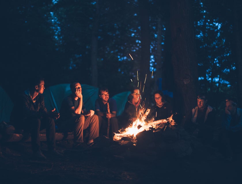 a group of campers around a campfire.