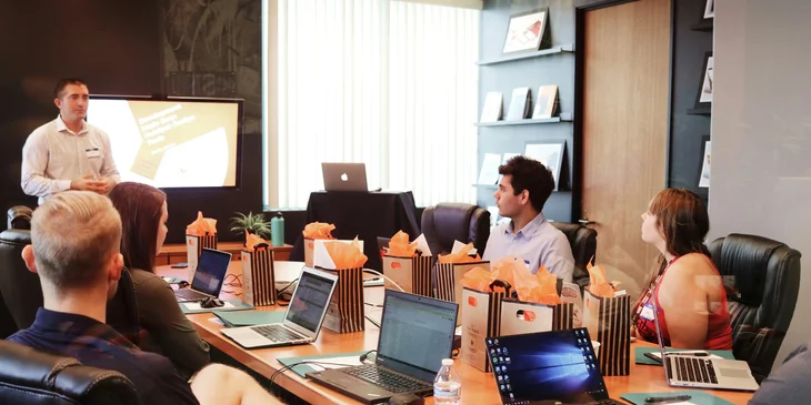 A campaign manager presenting the plan to his associates for the upcoming products.