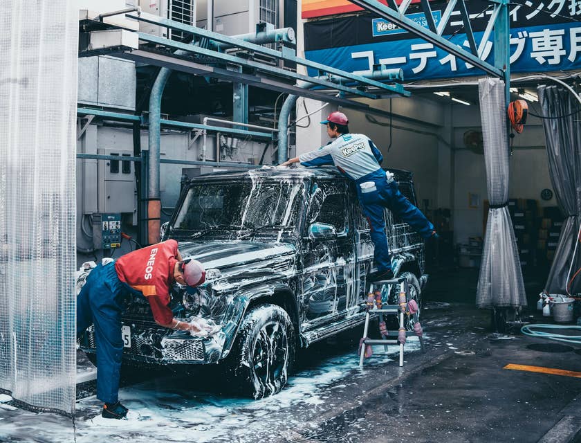 Car Detailers cleaning the exterior of a vehicle