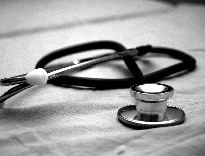 A cardiology technician's black and grey stethoscope on a white paper.