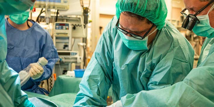 Cardiothoracic Surgeon performing a surgery to an old patient.