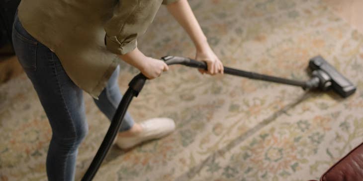 Carpet Cleaning Technician vacuuming a carpet