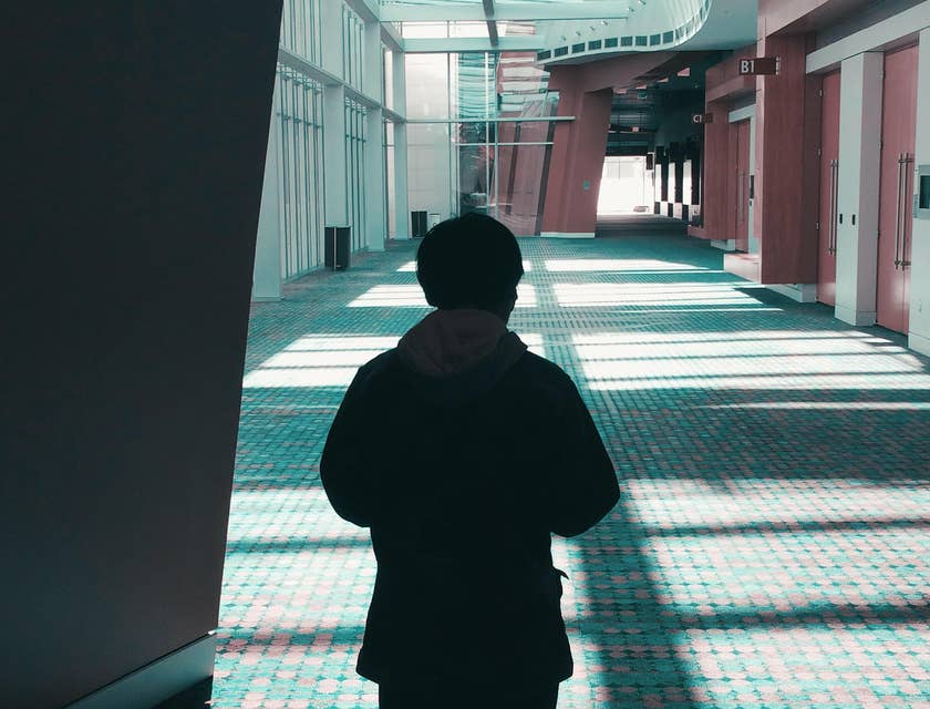man standing in a hall with wall-to-wall carpeting installed