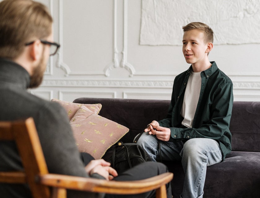 Caseworker on a counselling session with a man sitting on the couch