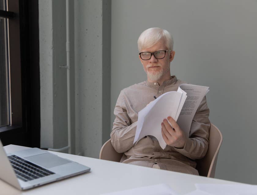 Casting Director reading the script of a specific character to determine which actor best suits the role