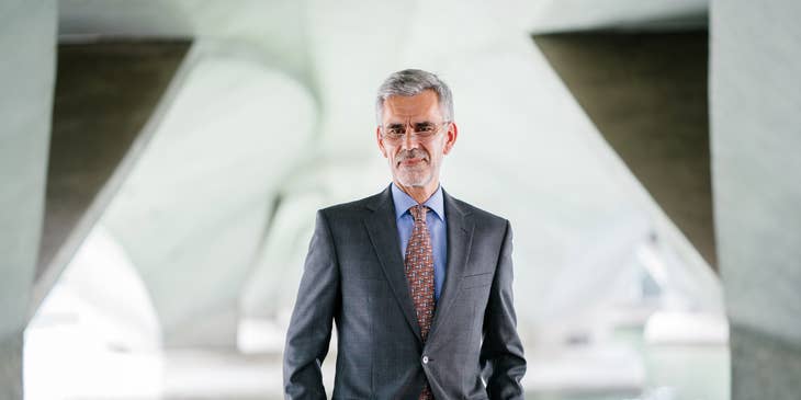 CEO posing for the camera outside his office for his corporate profile