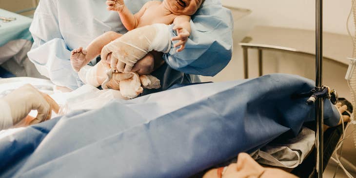 The Certified Nurse Midwife carries the newborn after delivery.