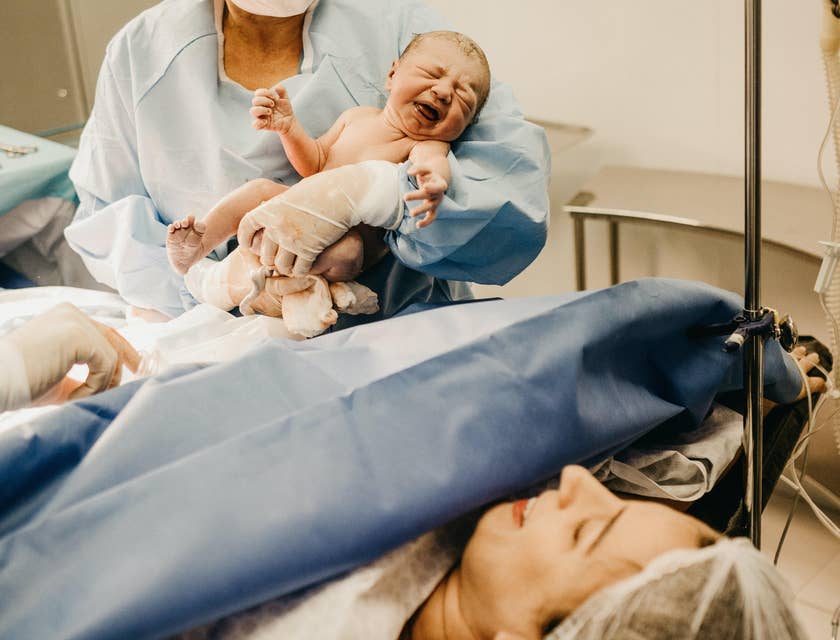 The Certified Nurse Midwife carries the newborn after delivery.