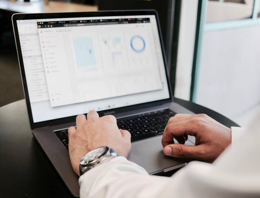 CFO reviewing the financial statements on his laptop for the organization's annual report