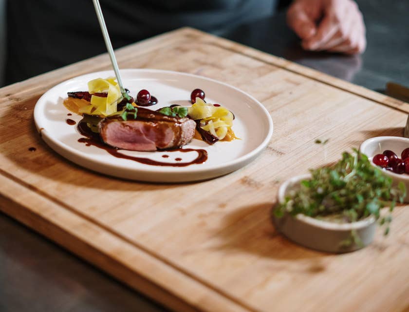 Chef de Partie carefully placed ingredients to create an art.