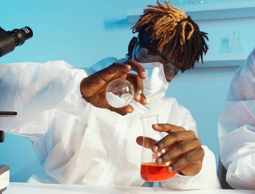 Chemist introducing a foreign compound to a certain liquid to induce reaction