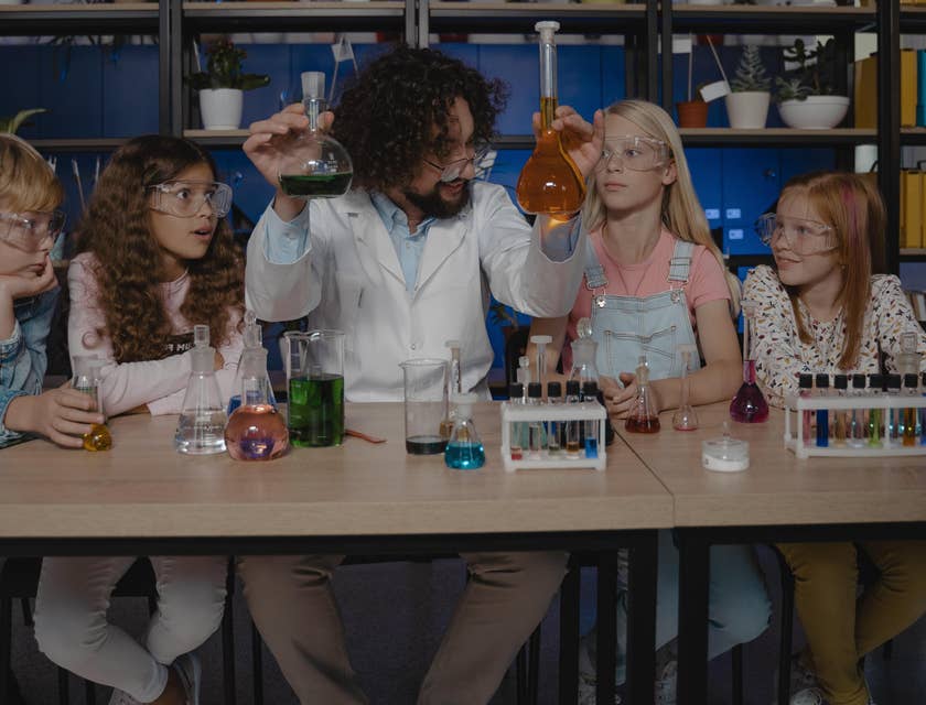 Chemistry Teacher explains different chemicals to his students in a laboratory