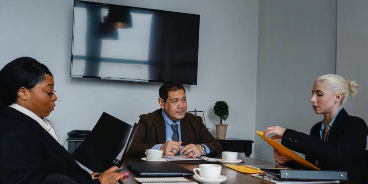 Chief Investment Officer pitching her investment proposal to other members of the executive team for approval