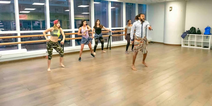 A choreographer rehearsing with dancers.
