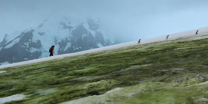 Climatologist hiking to the top of the mountain to setup a device and measure the temperature and atmospheric condition as well as get samples to be studied in the lab