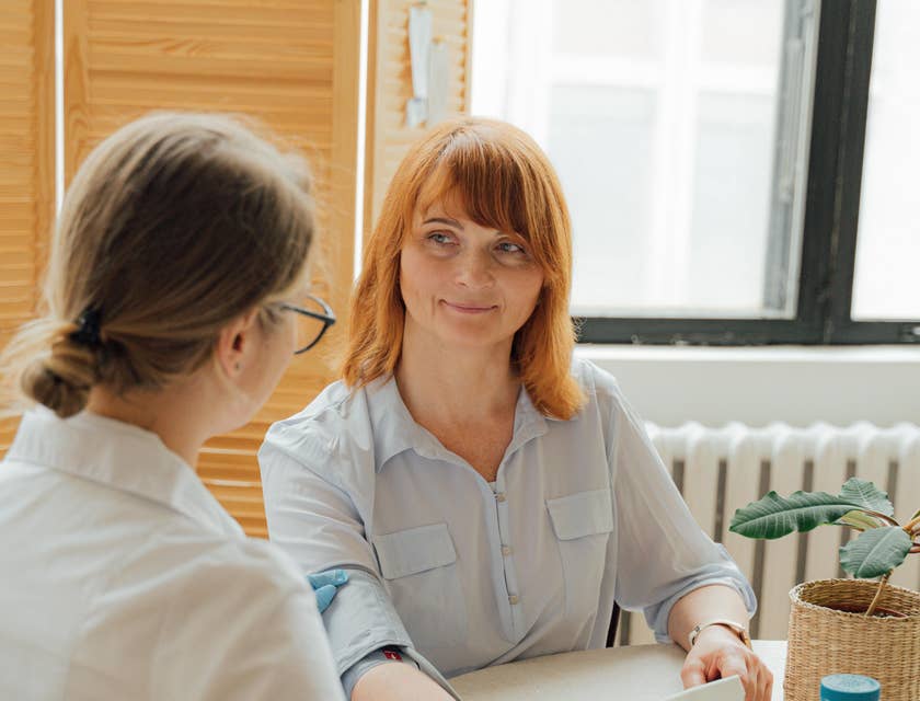 Clinical Nurse Specialist performing health assessment to a patient.