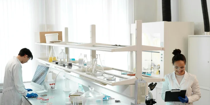 A female clinical trial manager writing notes on the progress of the clinical trial.
