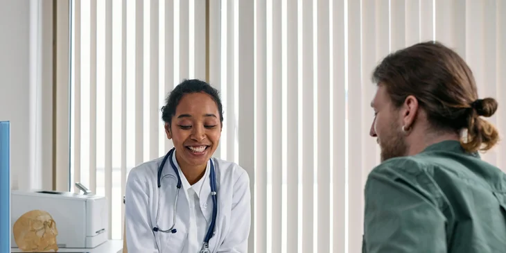 A clinician cheerfully explaining results to a patient.