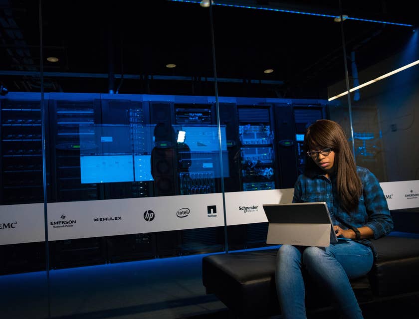 Cloud Engineer sitting outside the server room while running system tests